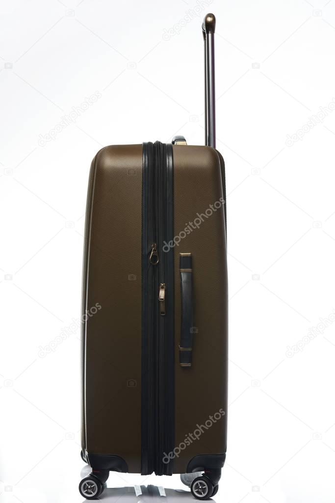 One large plastic brown suitcase