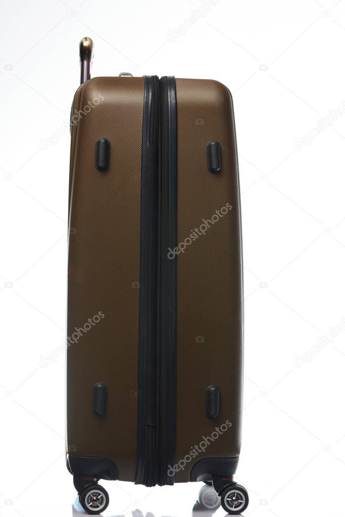 Side of closed brown suitcase