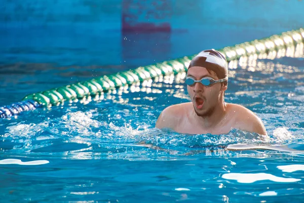 Man swim in pool lane