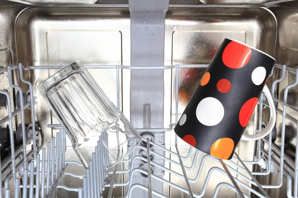 Clear glass and coffee mag in dishwasher