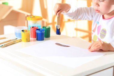 Boya fırça ile çocuk çizer