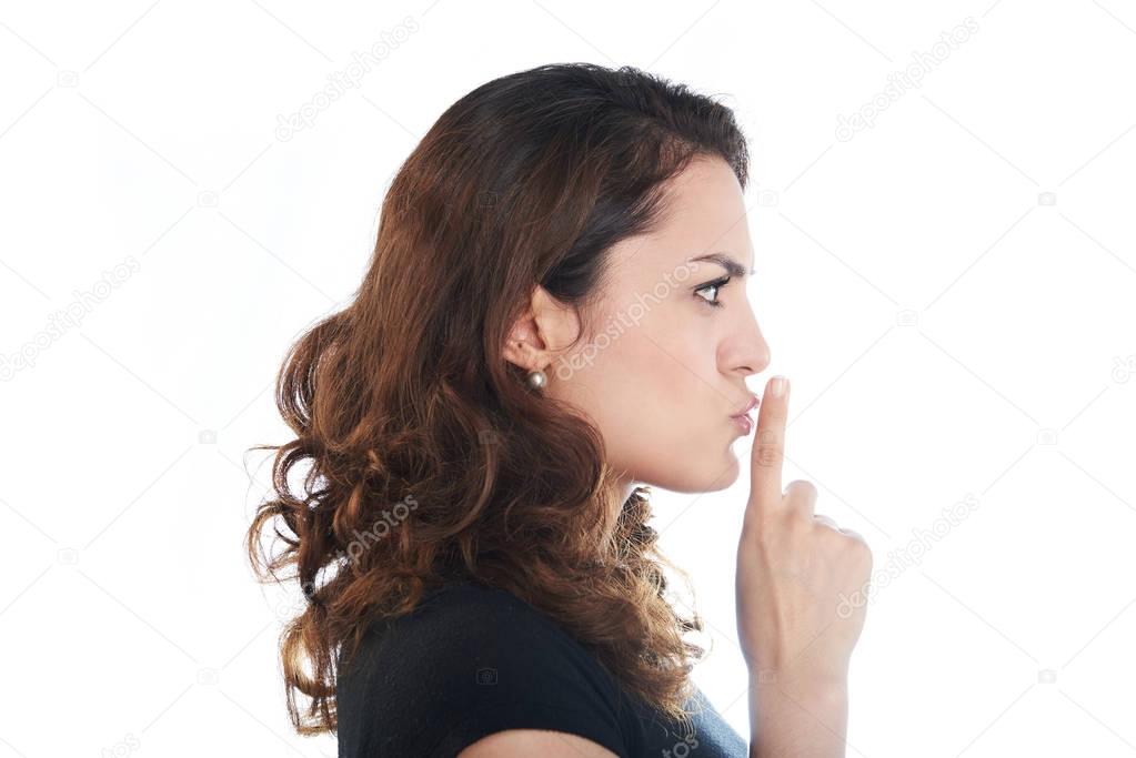 Profile of woman making shh sign