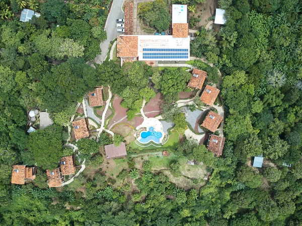 Aerial view on houses with pool in middle