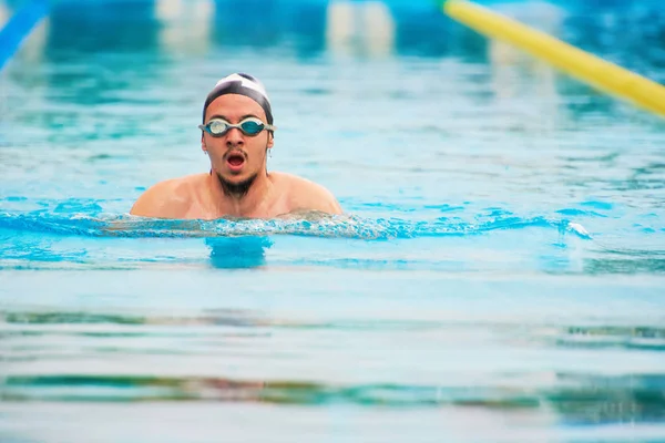 Man swim in pool lane