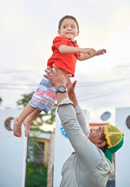 Smiling father playing with his son — Stock Photo, Image