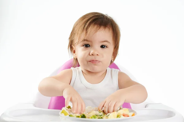 Funny face of baby girl with food — Stock Photo, Image