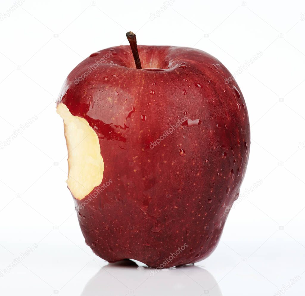 Fresh red apple with bite on side isolated on white background