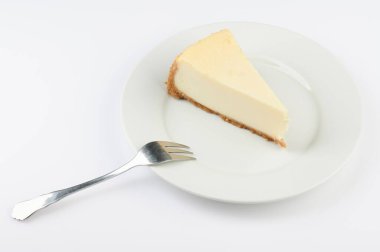 Bir dilim cheesecake tatlısı ve çatal yalıtılmış.