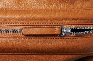 Kahverengi deri arka planda fermuar kilidini aç