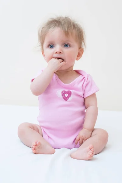 Teething Baby with her hand in her mouth — Stock Photo, Image