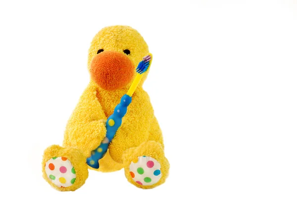 Bir oyuncak ördek yavrusu ve çocuğun diş fırçası. — Stok fotoğraf