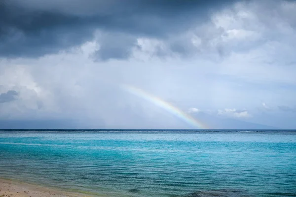 Rainbow on Temae Beach lagoon in Moorea island