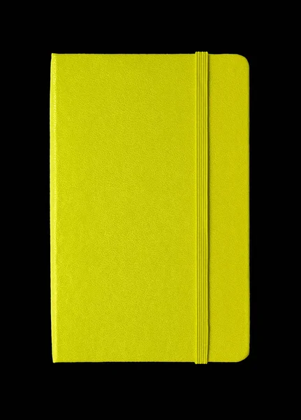 Lime green closed notebook isolated on black — ストック写真