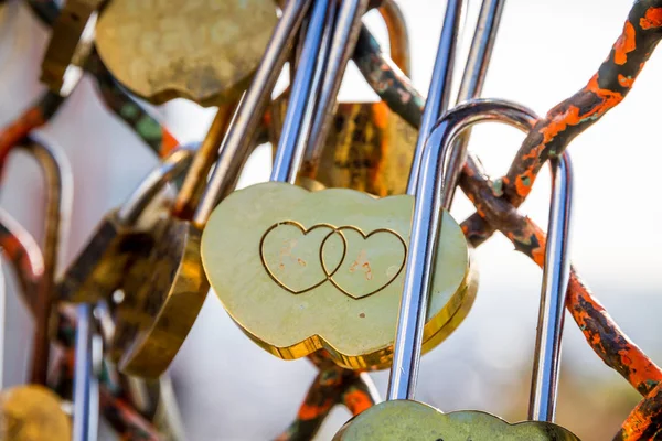 Padlocks symbols of love hanging on a fence — Stock Photo, Image