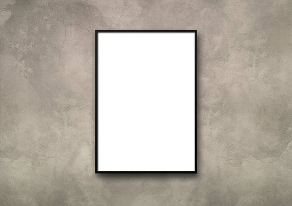 Black picture frame hanging on a light concrete wall. Blank mockup template