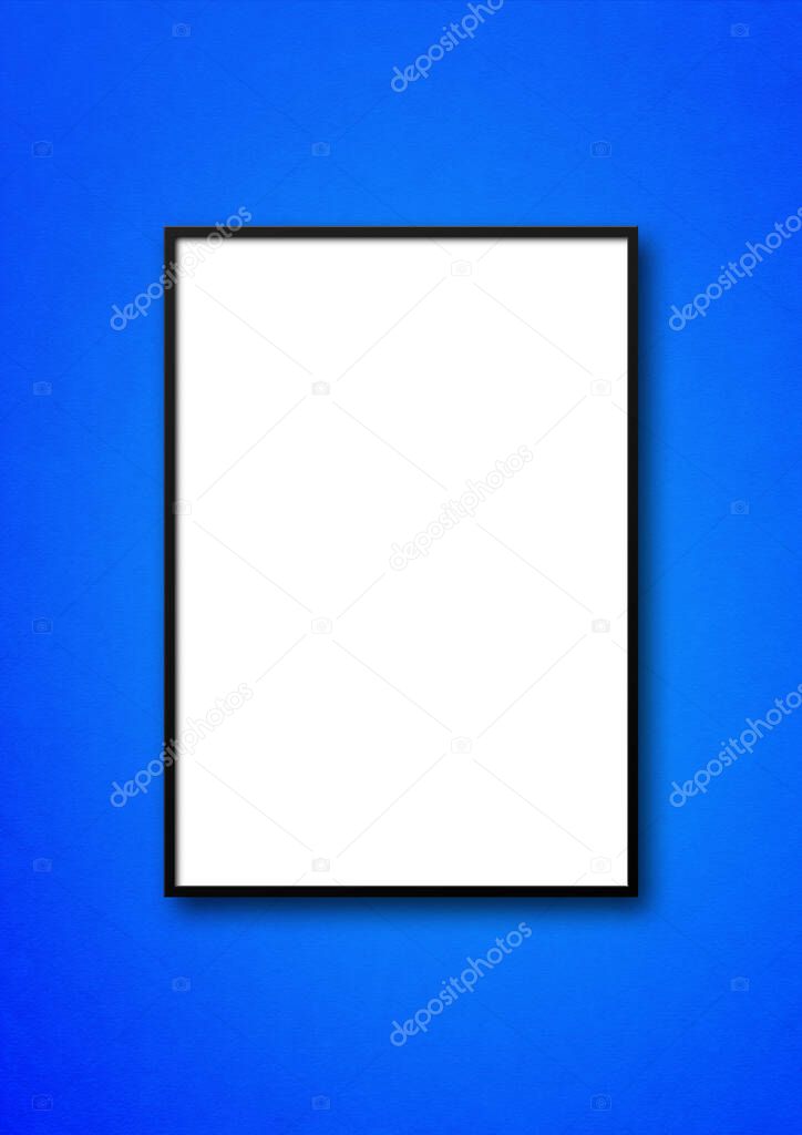 Black picture frame hanging on a blue wall. Blank mockup template