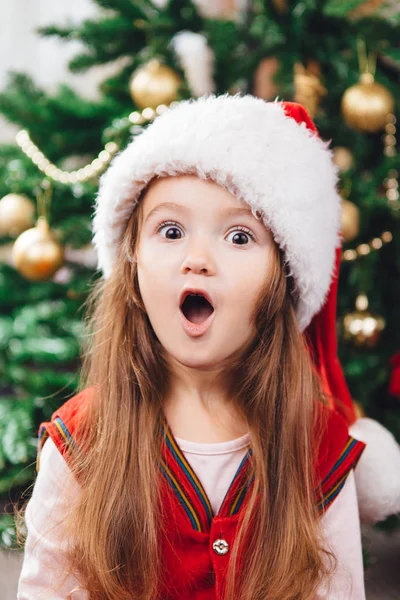 stock image Surprised girl in red christmas hat