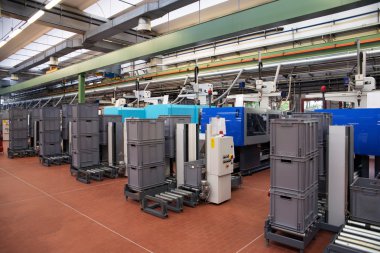 Injection molding machines in a large factory clipart