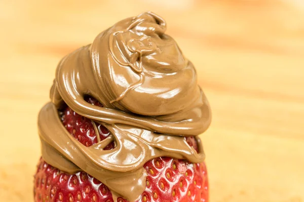 Close up of strawberry covered in chocolate spread. — Stock Photo, Image