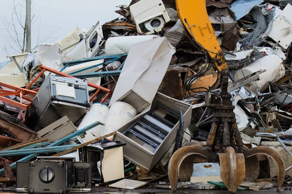 Metal recycling yard. Powerfull mechanical grabbyng arm.