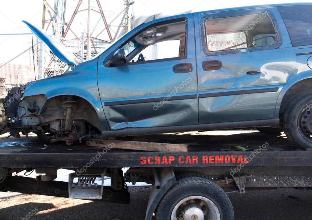 Recycling scrap car removal service for future dismantling and metal and parts reuse.
