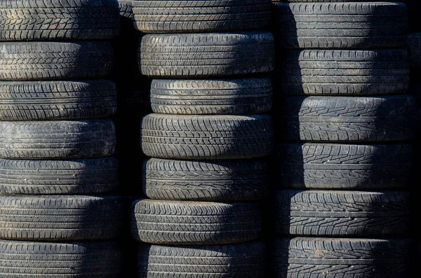 used auto tires stacked in piles