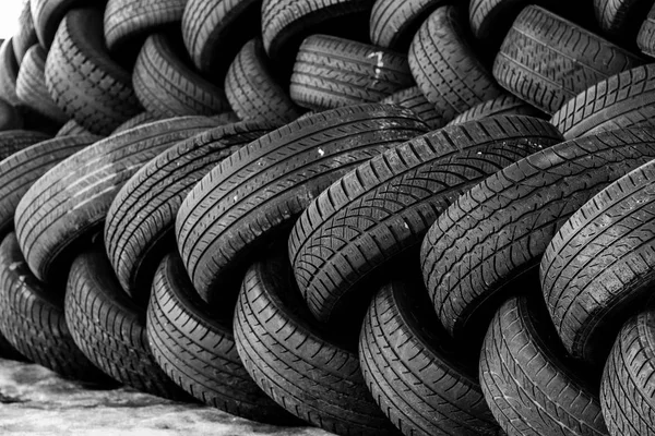 used auto tires stacked in piles