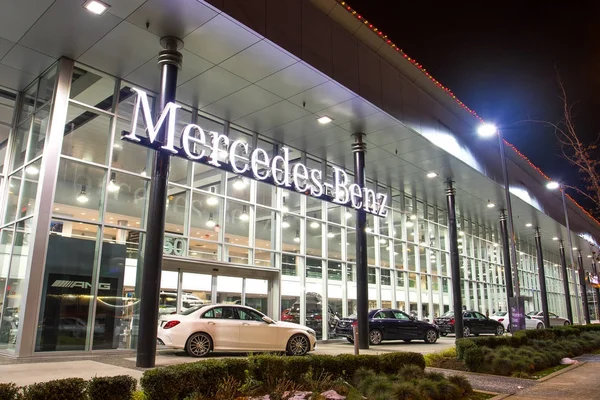 Vancouver BC, Canada - January 9, 2018: Office of official dealer Mercedes-Benz. Mercedes-Benz is a German automobile manufacturer Night shot all sings and inside of the building is illuminated. — Stock Photo, Image