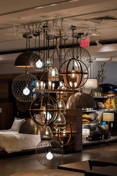 Elegant light fixture on display in furniture store with edison type light bulbs.