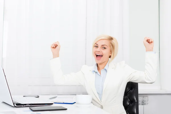 Business woman excited at modern office desk Stock Photo