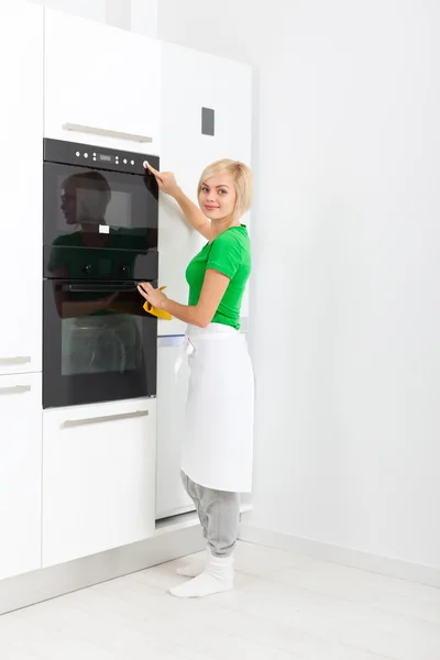 Vrouw druk op knop moderne keuken toestel — Stockfoto
