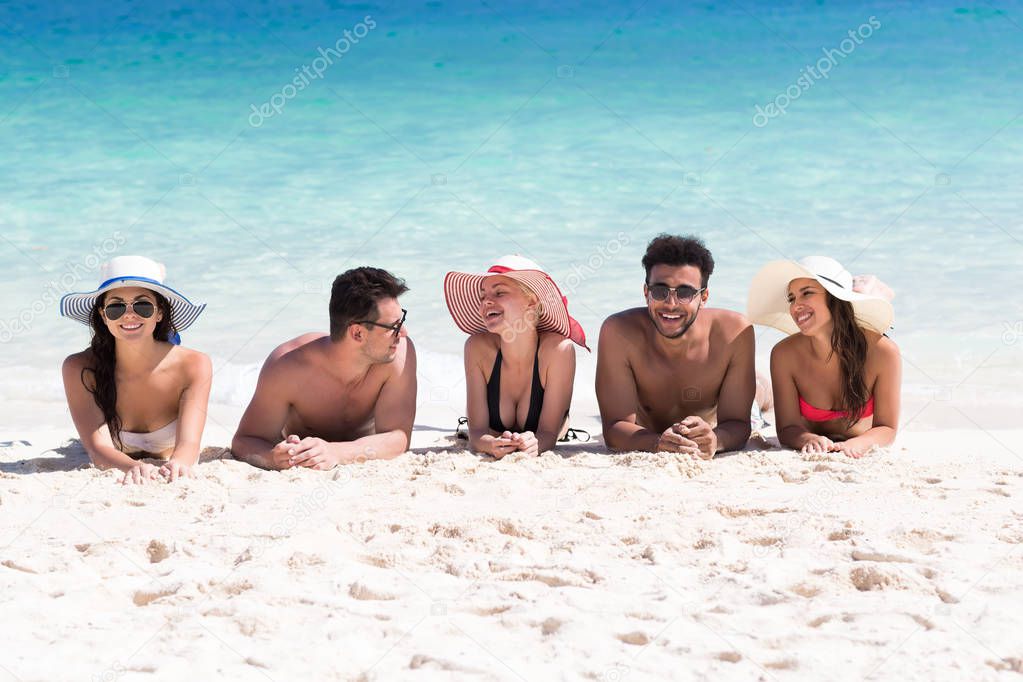 Young People Group On Beach Summer Vacation, Happy Smiling Friends Lying Sand Seaside