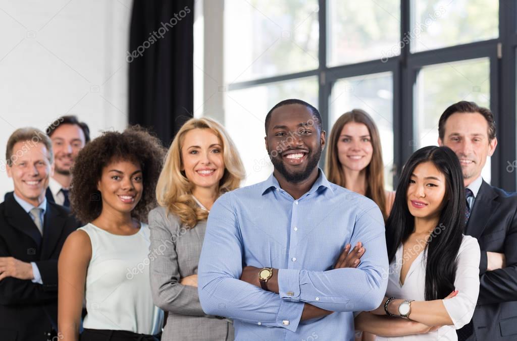 African American Businessman Boss With Group Of Business People In Creative Office, Successful Mix Race Man Leading Businesspeople Team Stand Folded Hands, Professional Staff