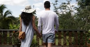 Eller güzel tropikal peyzaj geri ile yaz terasında yürümek tutan çift erkek ve kadın görünümü açık havada birlikte arka