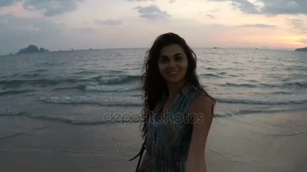 Joven mujer caminando en playa sosteniendo la mano del hombre al atardecer acción cámara punto de vista de feliz sonrisa chica en la playa — Vídeos de Stock