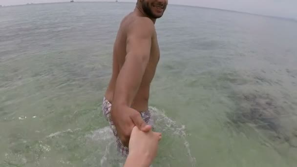 라틴 남자 액션 카메라 Pov 해변에 젊은 한 쌍의 이야기 하는 손을 잡고 바다 물에 도보 — 비디오