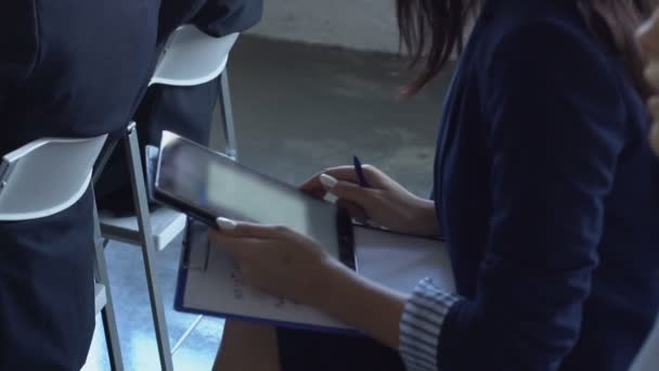 Business Woman Holding Digital Tablet Computer Listening To Presentation On Seminar Sitting With Colleagues — Stok Video