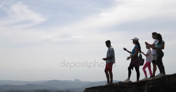 Skupina turistů na vrchol hory, lidé vychutnat krajinu s východem slunce fotografování na chytrý mobil — Stock video