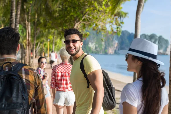 Grupa ludzi, chodzenia w Palm Tree Park na plaży rozmowy, dorywczy przyjaciele turystów — Zdjęcie stockowe
