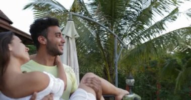 İspanyol insan taşımak kadın terasta açık havada, tropikal ormanda günbatımı üzerinde konuşurken aşk mutlu çift