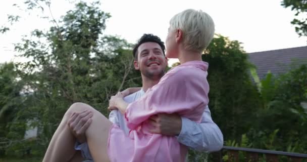 Man Holding Woman On Hands At Terrace Talking, Young Couple Looking At Sunset Over Tropical Forest — Stock Video