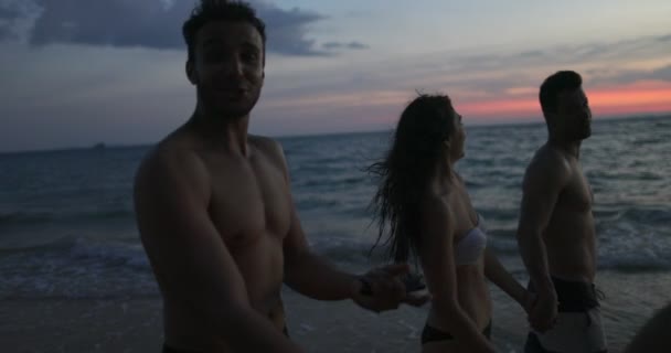 Группа людей веселые разговоры прогулки по пляжу на закате POV, счастливые Frineds на летний морской праздник — стоковое видео