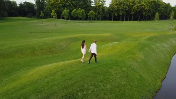 젊은 커플 여름 공원에서 산책, 남자와 여자를 촬영 하는 무인 항공기를 돌고의 항공 보기 — 비디오