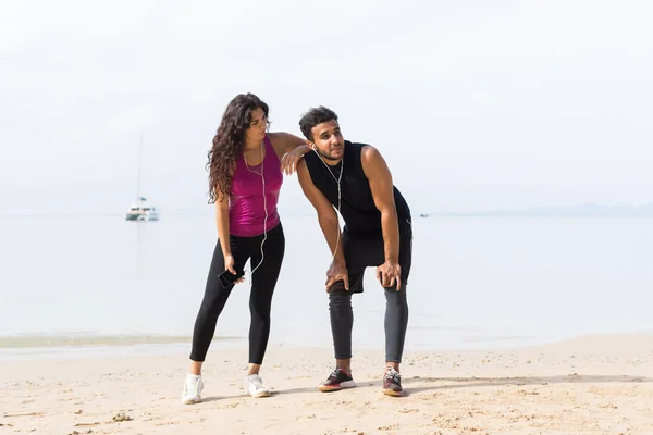 Couple Of Runner Having Rest After Training On Beach Man And Woman Sport Runners Standing Fit Male And Female Fitness Jogger