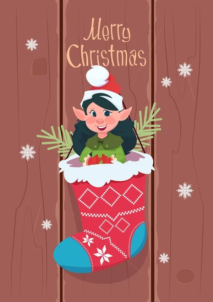 Joyeux Noël et bonne année carte de vœux avec elfe accroché dans le présent chaussette vacances d'hiver Bannière concept — Image vectorielle