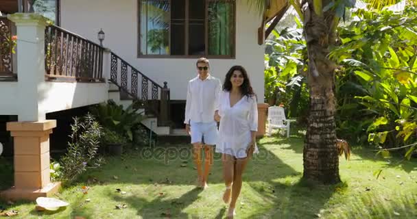 Woman Leading Man Walking In Tropical Garden Near Villa House, Happy Couple Outdoors Lovers On Vacation — Stok Video