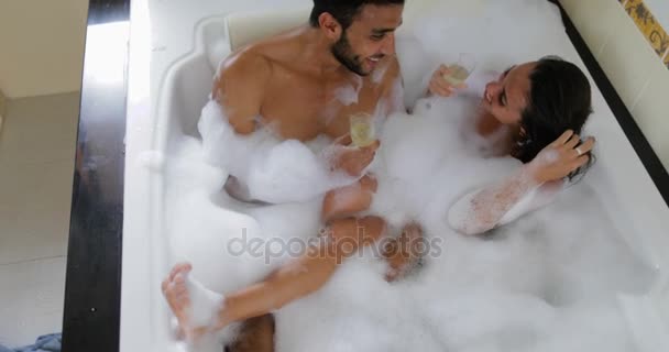 Young Couple In Bath Together Drink Champagne Talking Top Angle View, Man And Woman Lover Enjoy Spa At Home Stock Video