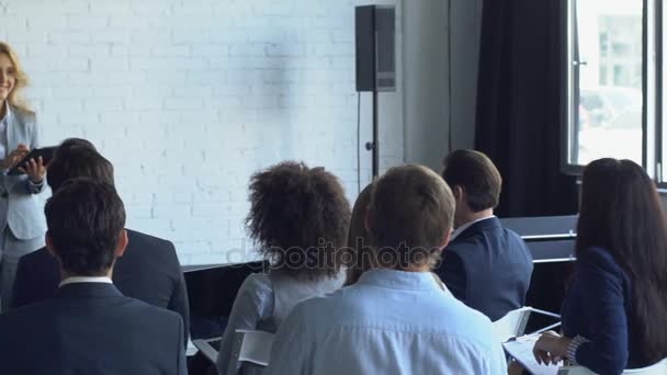 Group Of Business People Asking Question To Businesswoman Leading Presentation Discussing Financial Report Stock Footage