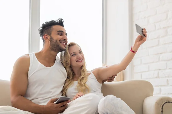 Young Beautiful Couple Sit On Coach Window, Taking Selfie Photo On Cell Smart Phone Happy Smile — Stock Photo, Image