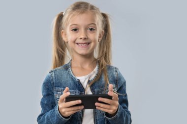 Güzel küçük kız hücre kullanarak akıllı izole telefon mutlu gülümseyerek aşınma Kot ceket